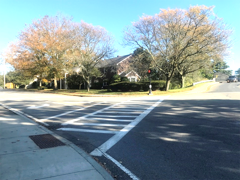 Figure 8 - Southeast Corner of Study Intersection. Image shows multifamily housing, large trees, and a long crosswalk stretching across Linden Street.